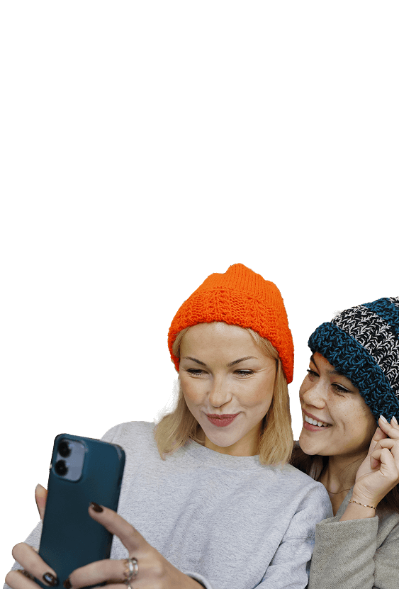 Two women in knit hats taking a selfie together.